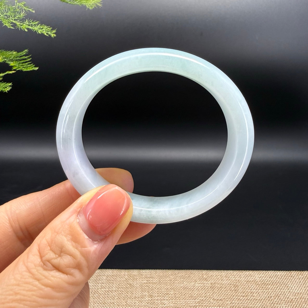 The bangle shape of the oval half round.The bangle color is white green.