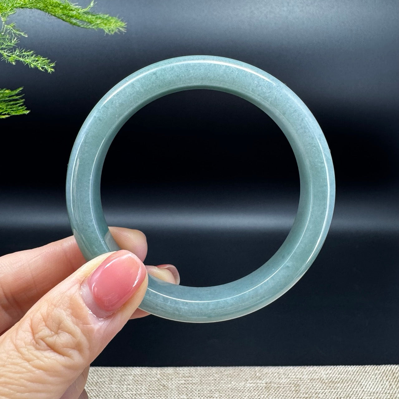 The bangle shape of the half round.The bangle color is green.