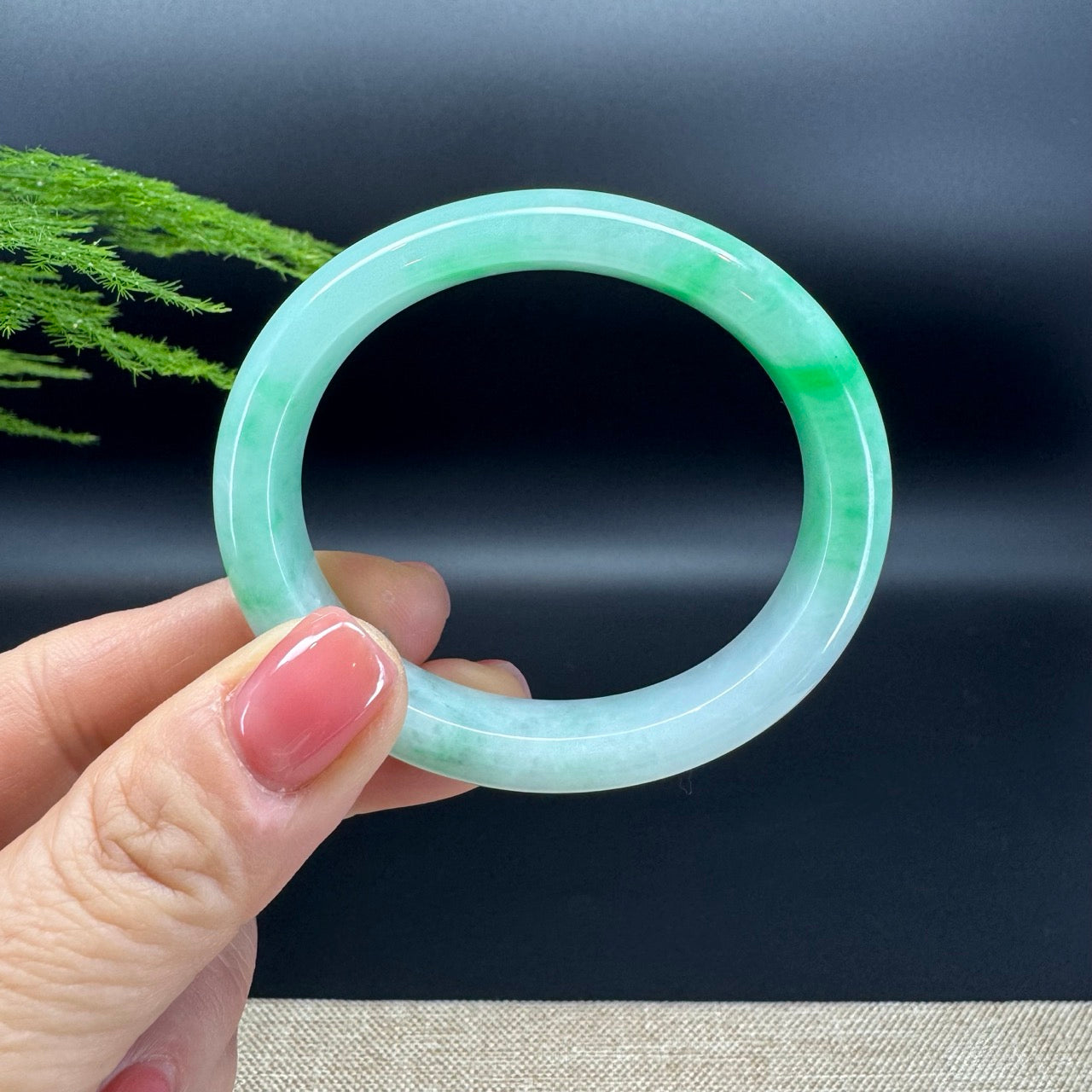 The jade is extremely smooth in texture and presents white green(BDC, moss in snow).