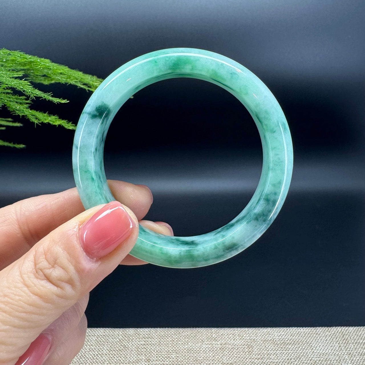 The bangle shape of the half round.The bangle color is blue green.