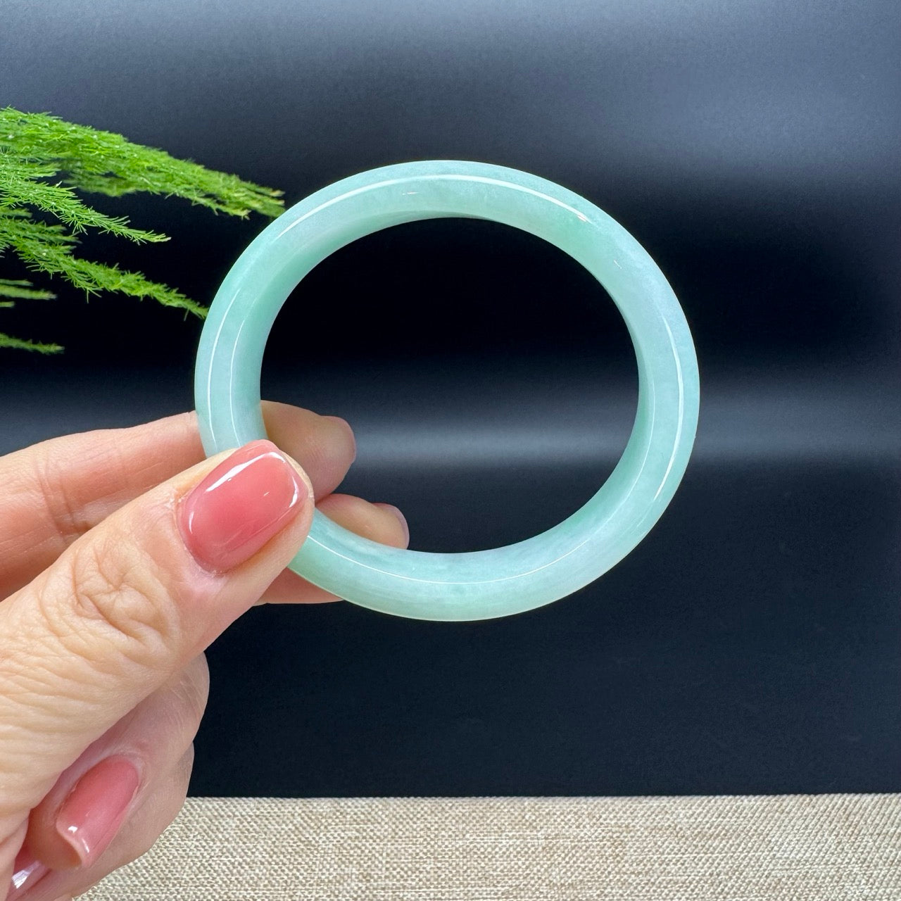 The bangle shape of the oval half round.The bangle color is green.