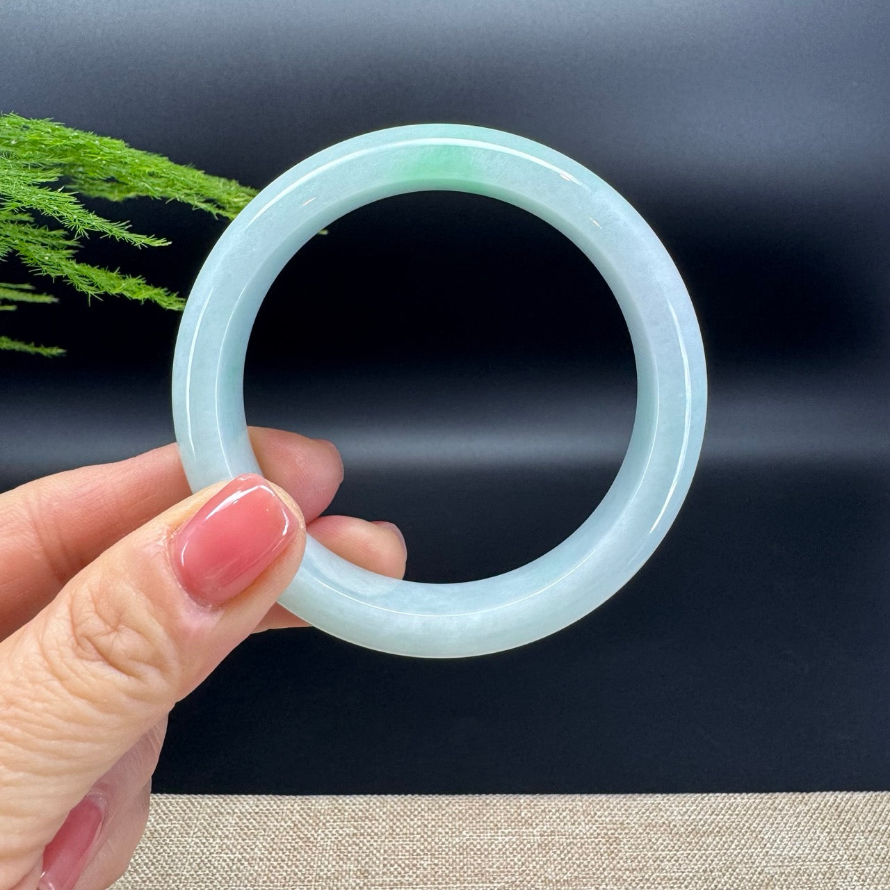 The bangle shape of the half round.The bangle color is white green.