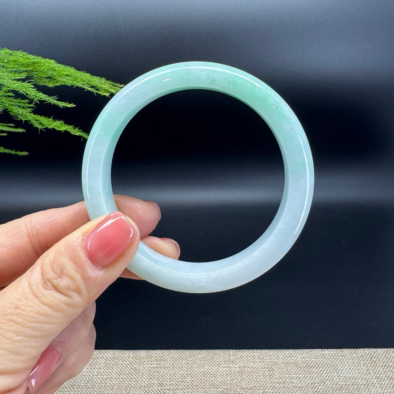 The bangle shape of the half round.The bangle color is white green.