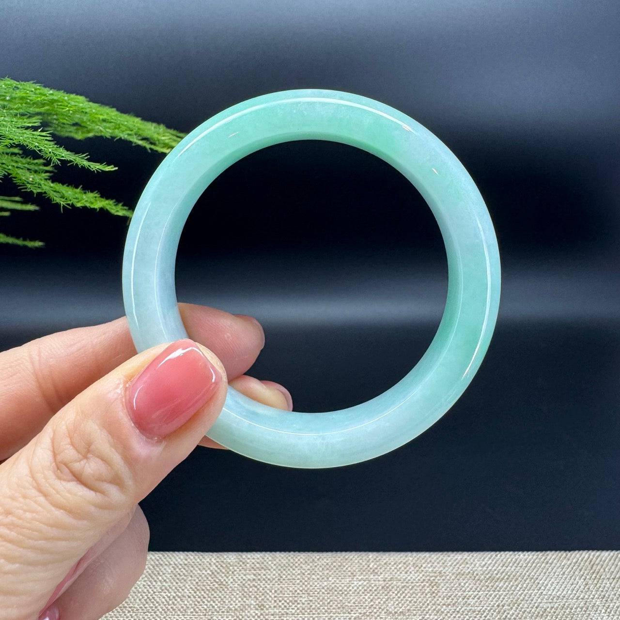 The bangle shape of the half round.The bangle color is white green.