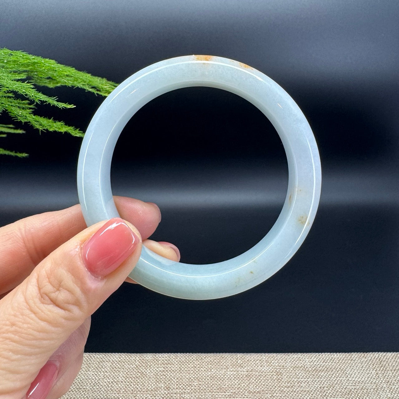The bangle shape of the half round.The bangle color is light green and some sajin.