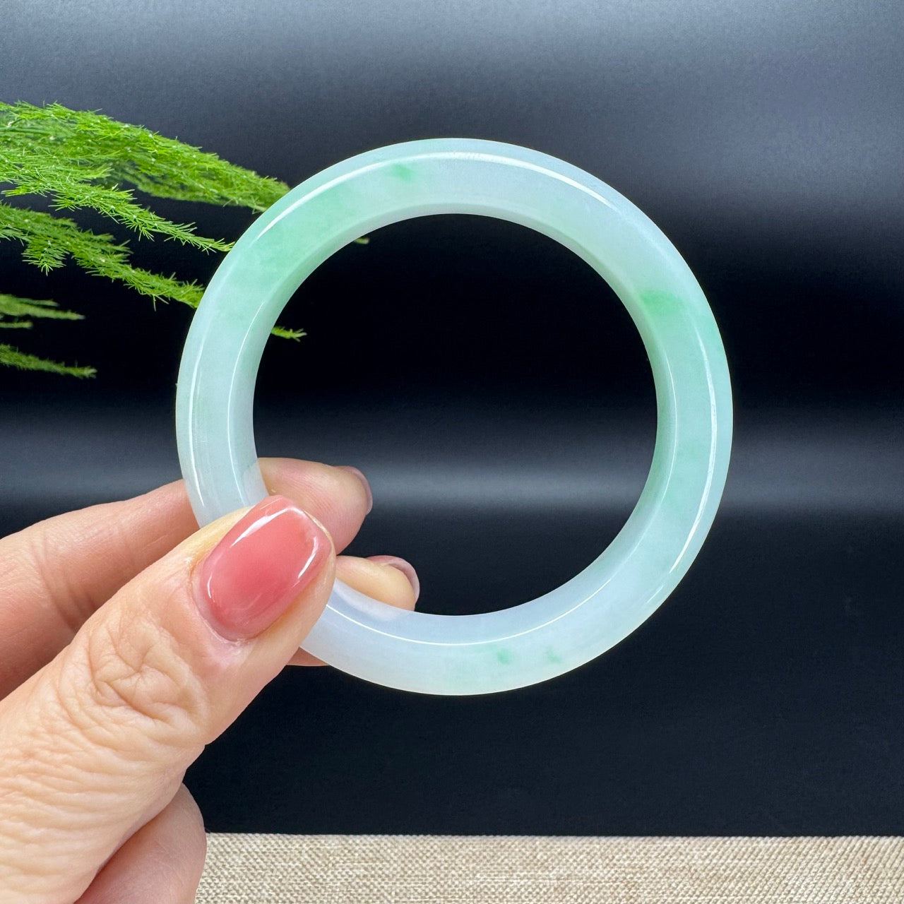 The bangle shape of the half round.The bangle color is white green.