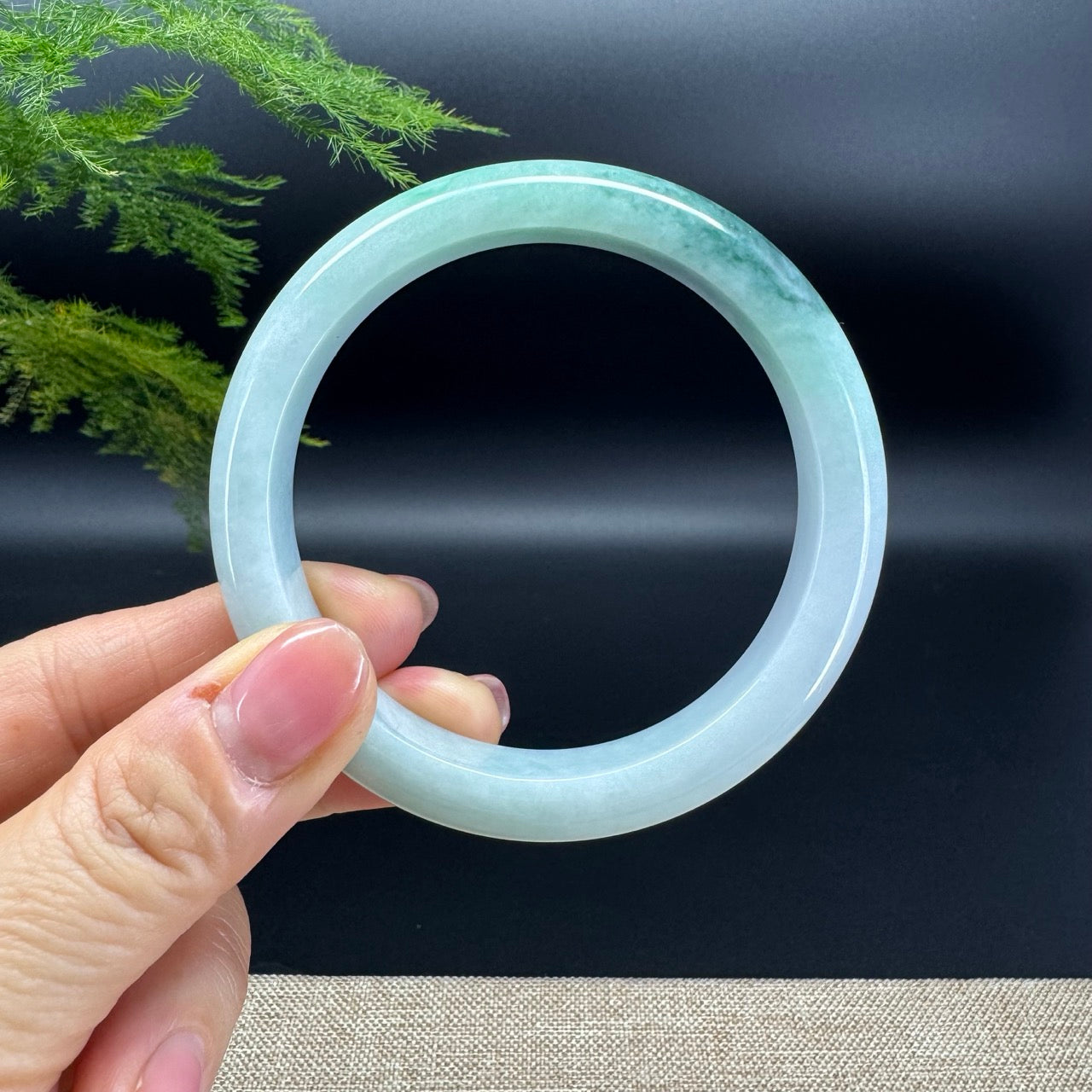 The bangle shape of the half round.The bangle color is oil green and little lavender.