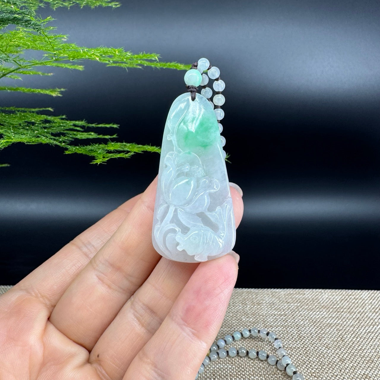 The pendant shape of the fish and lotus flowers.The pendant color is icy white green.