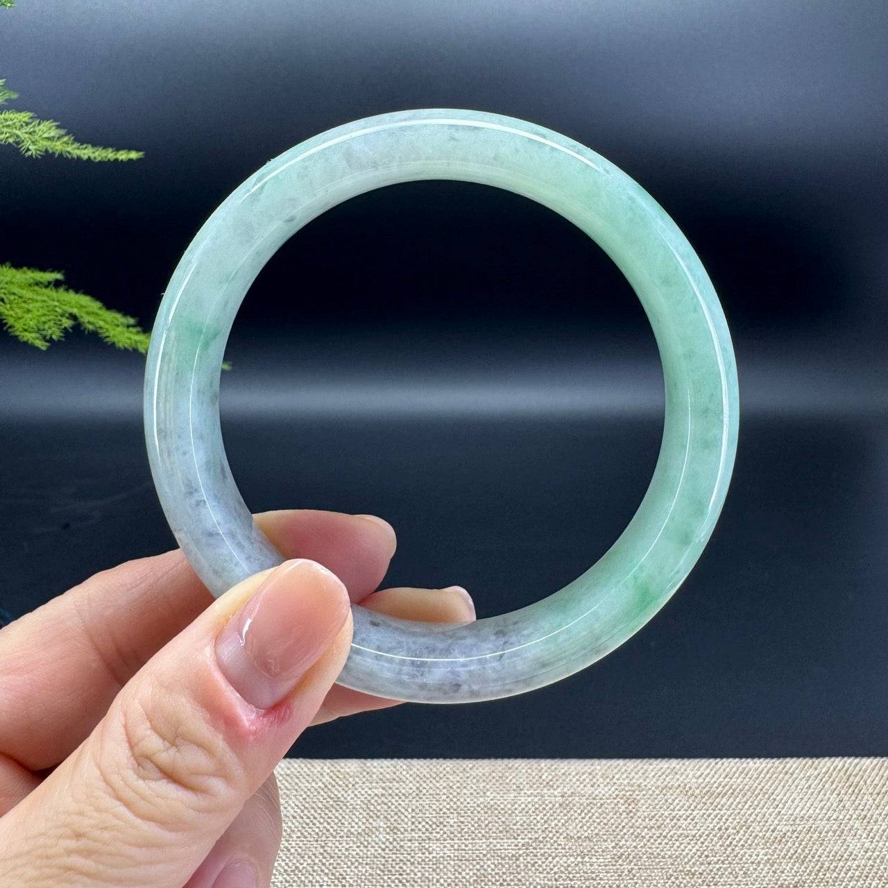 The bangle shape of the half round.The bangle color is icy wuji green.