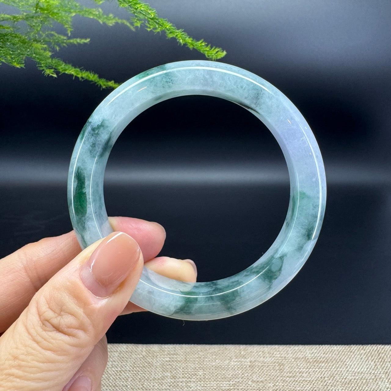 The bangle  shape of the half round.The bangle color is blue green.