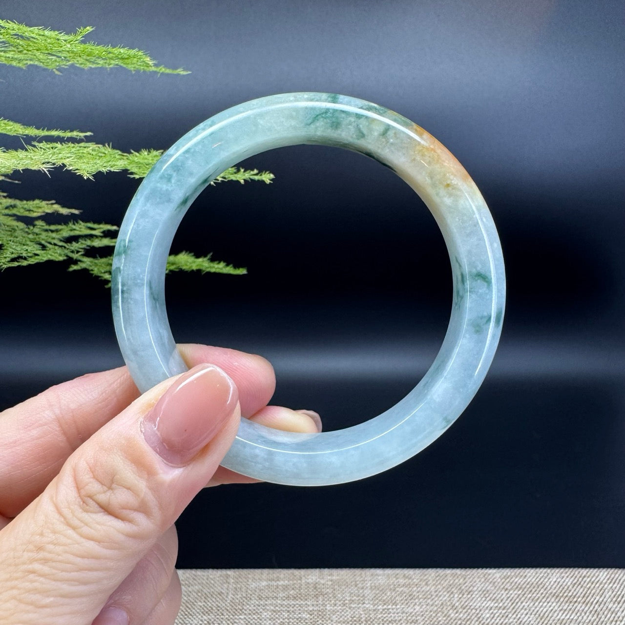 The bangle shape of the half round.The bangle color is icy blue green.