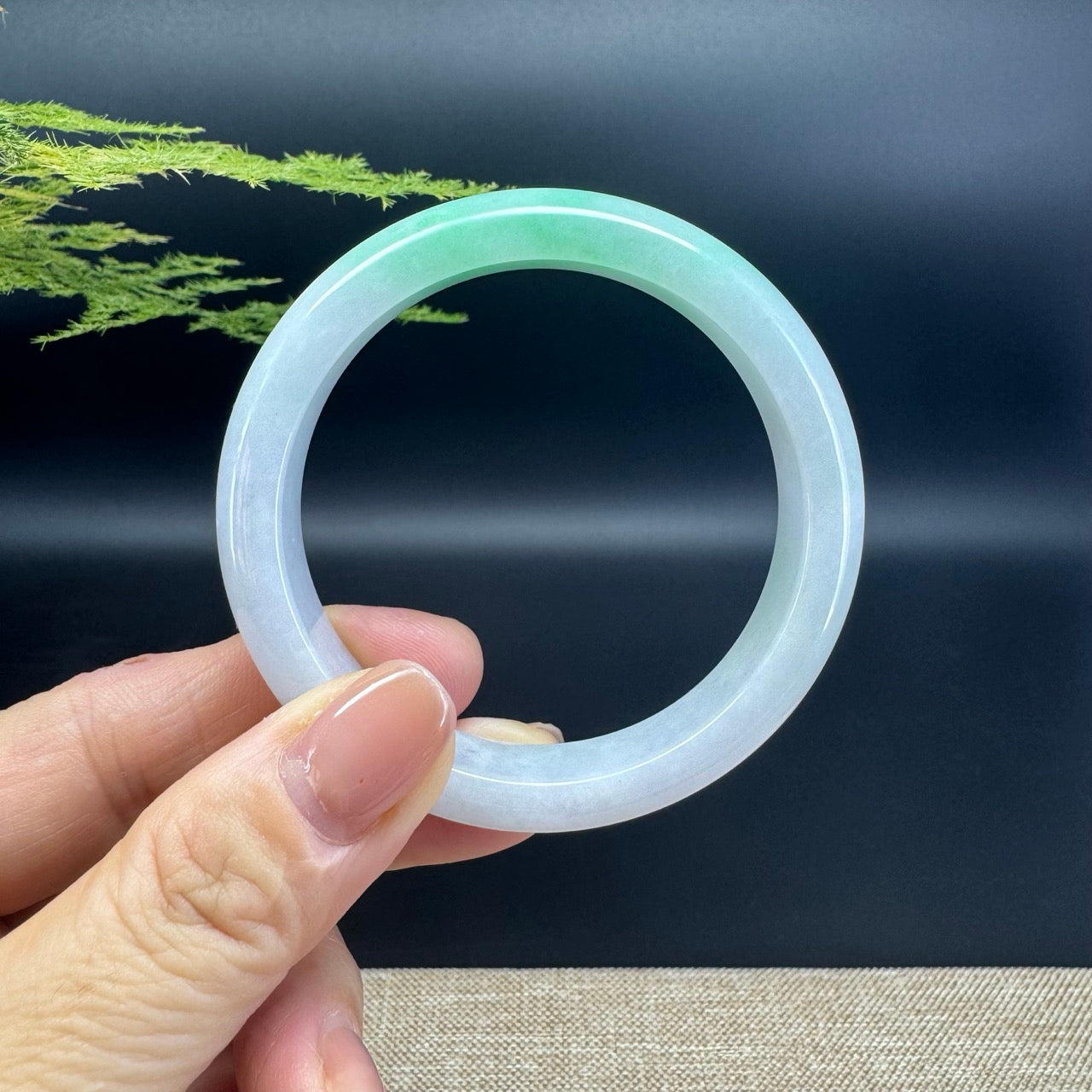 The bangle shape of the half round.The bangle color is white green.