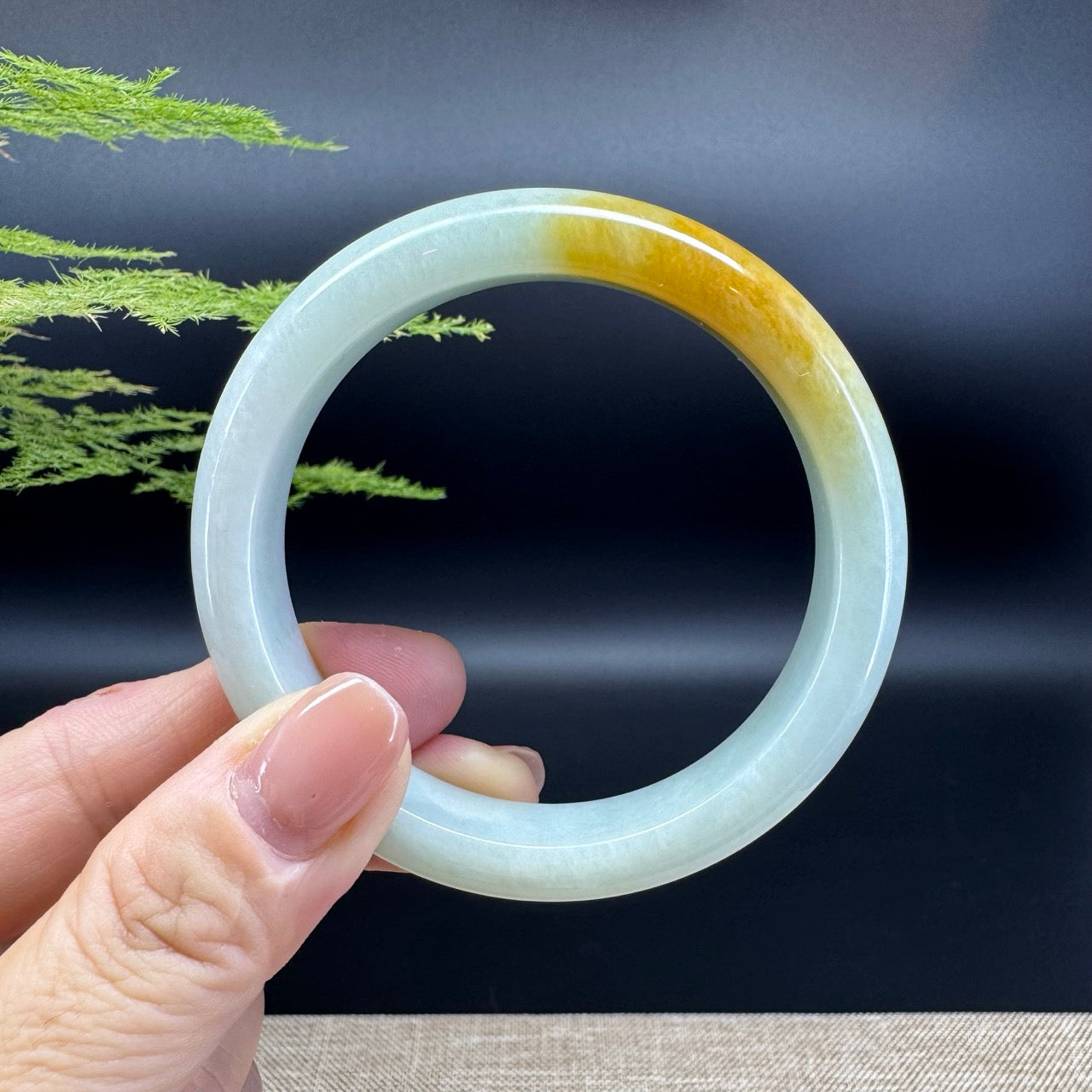 The bangle shape of the half rounf.The bangle color is yellow green.
