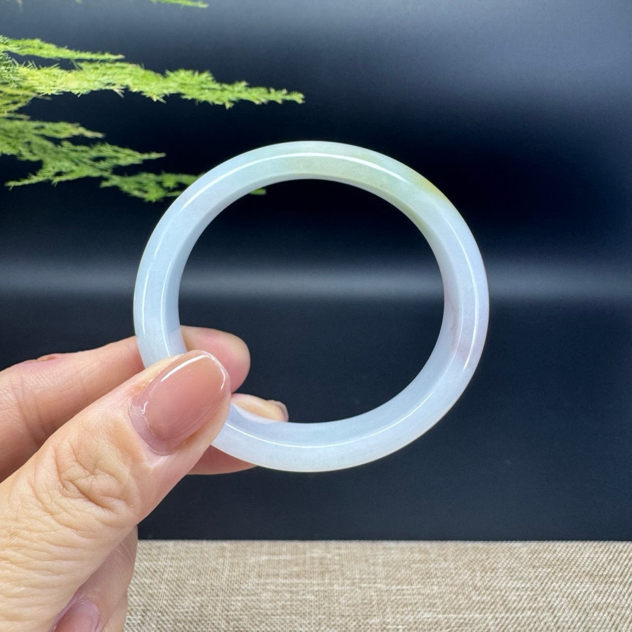 The bangle shape of the oval half round.The bangle color is yellow green.