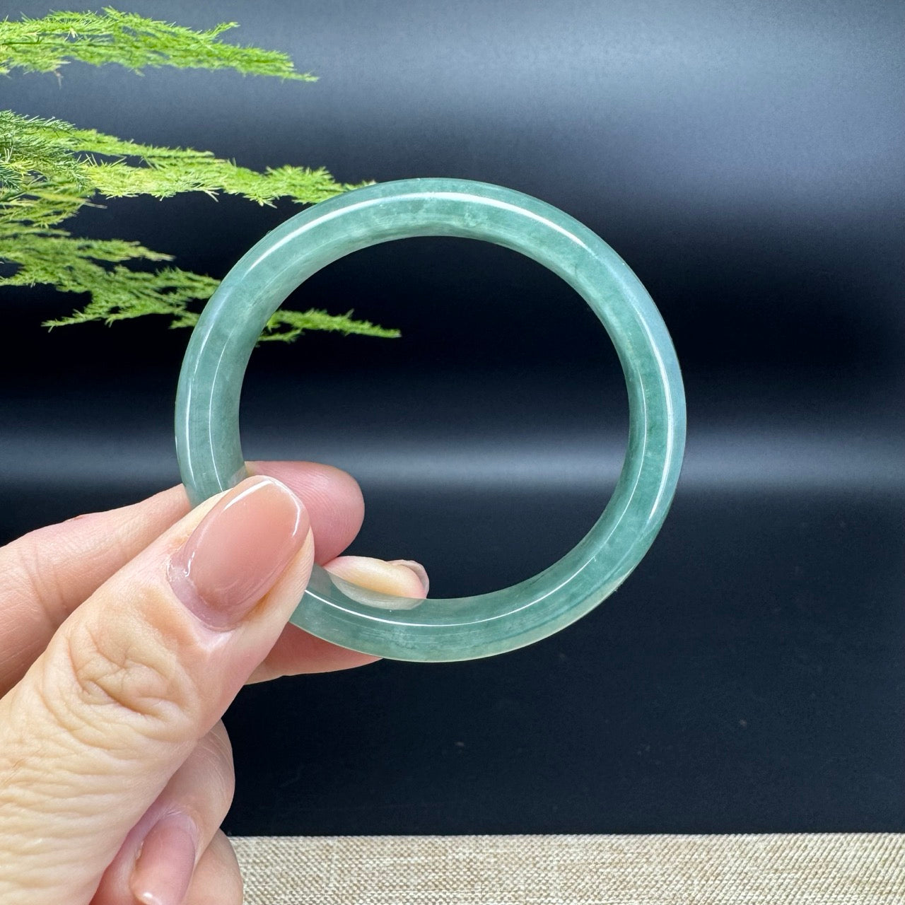 The bangle shape of the half round.The bangle color is green.