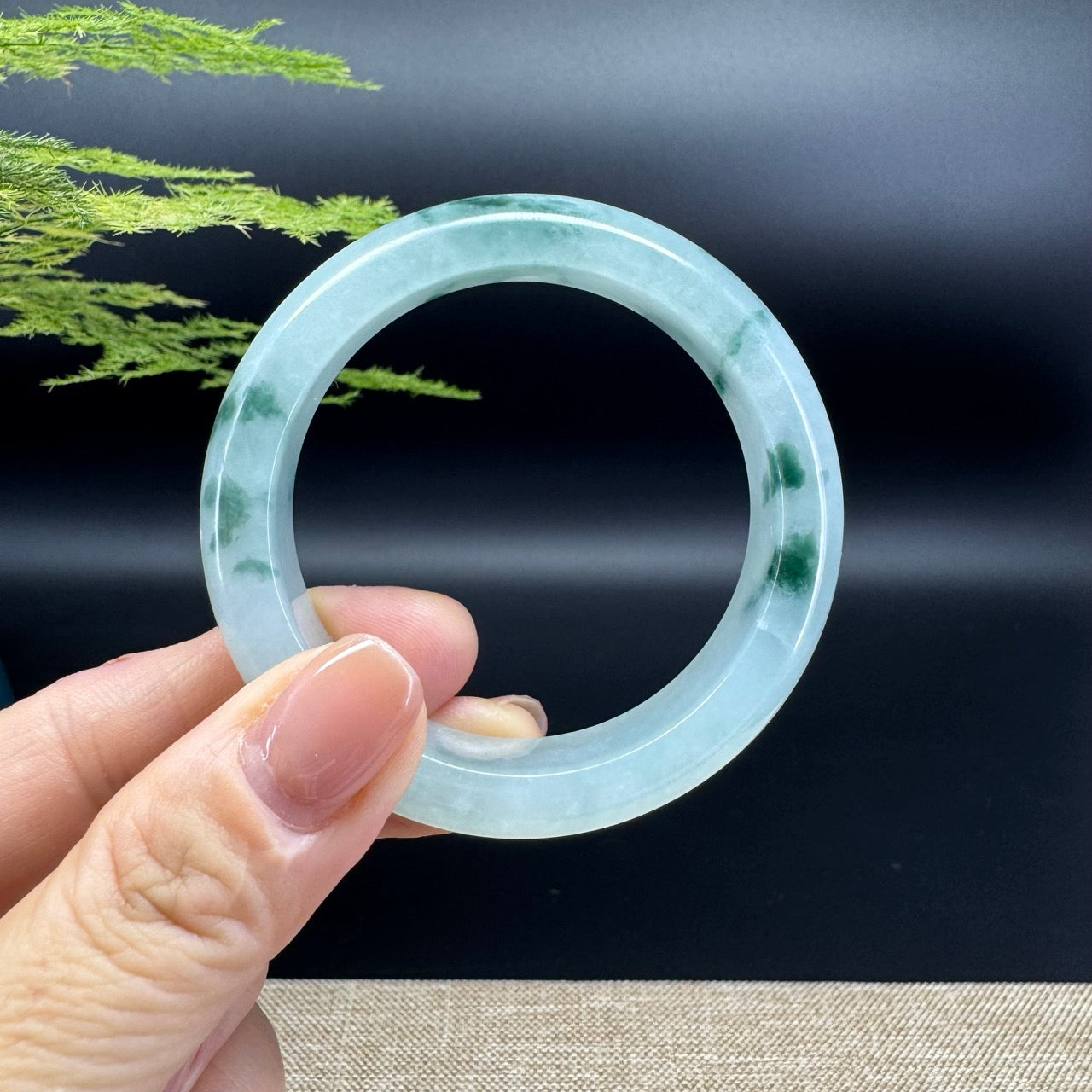 The bangle shape of the half round.The bangle color is icy blue green.