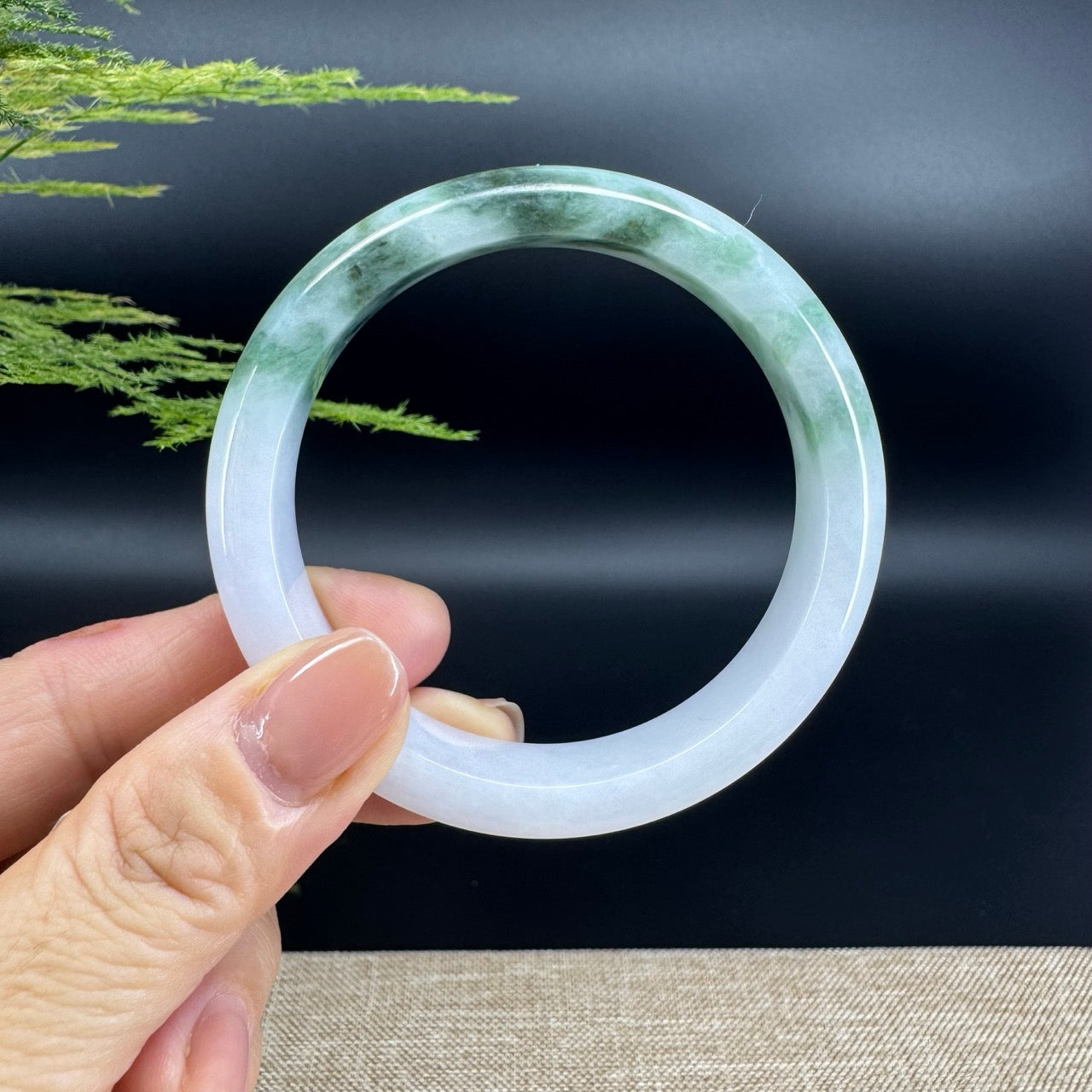 The bangle shape of the half round.The bangle color is white green.