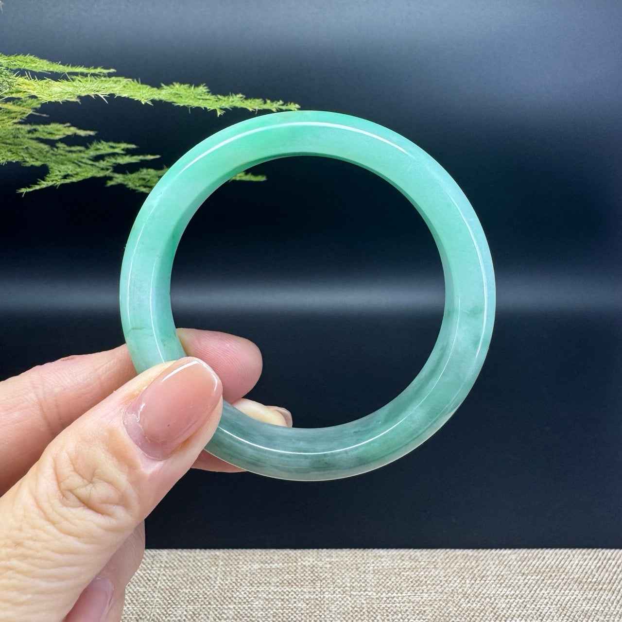 The bangle shape of the half round.The bangle color is green.