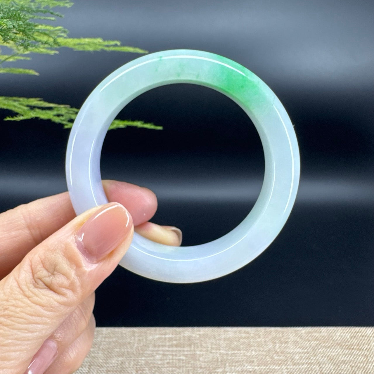The bangle shape of the half round.The bangle color is white green.