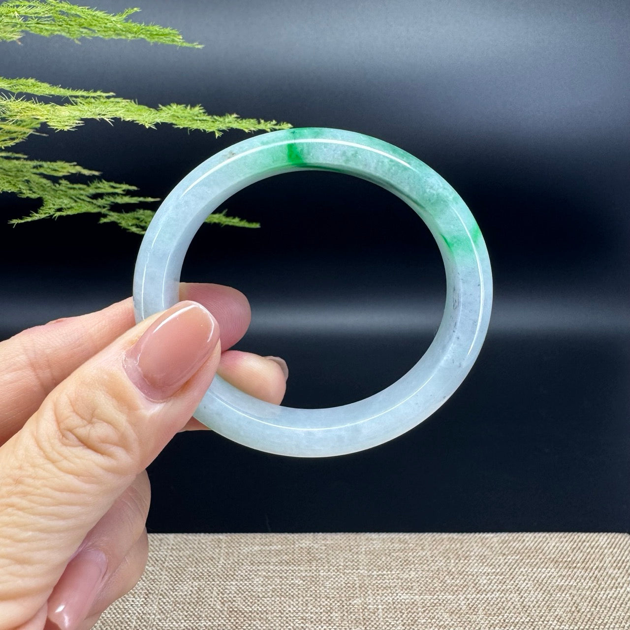 The bangle shape of the oval half round.The bangle color is white green and some wuji.