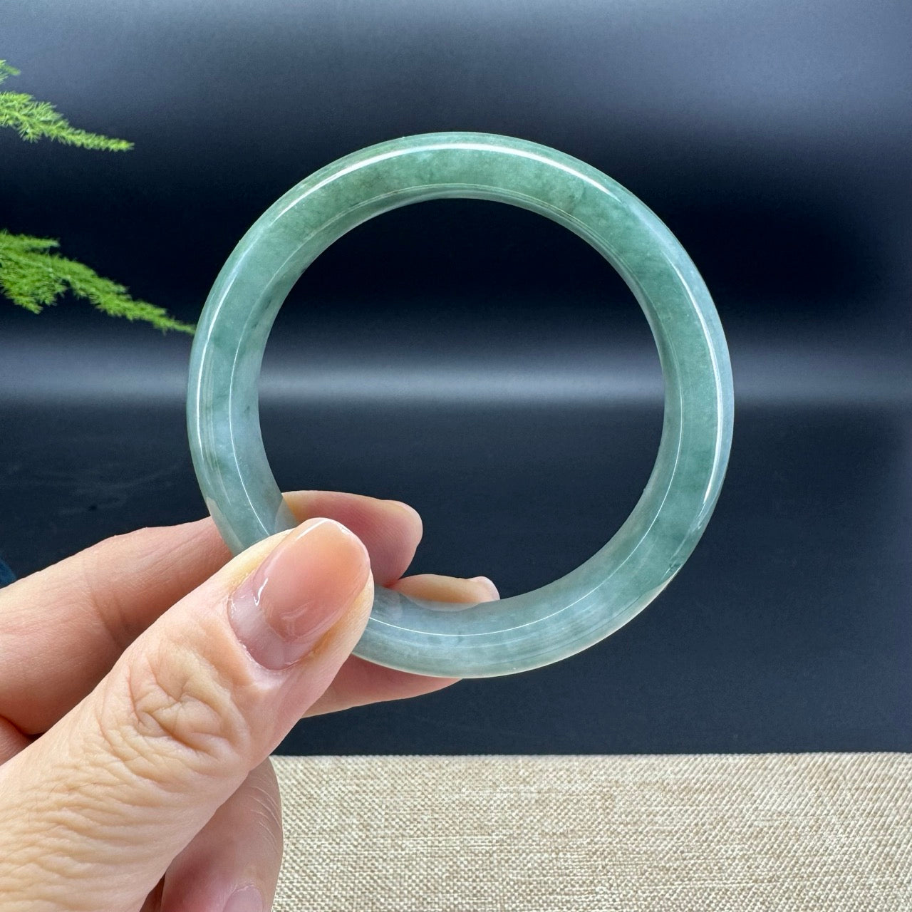 The bangle shape of the half round.The bangle color is forest green.