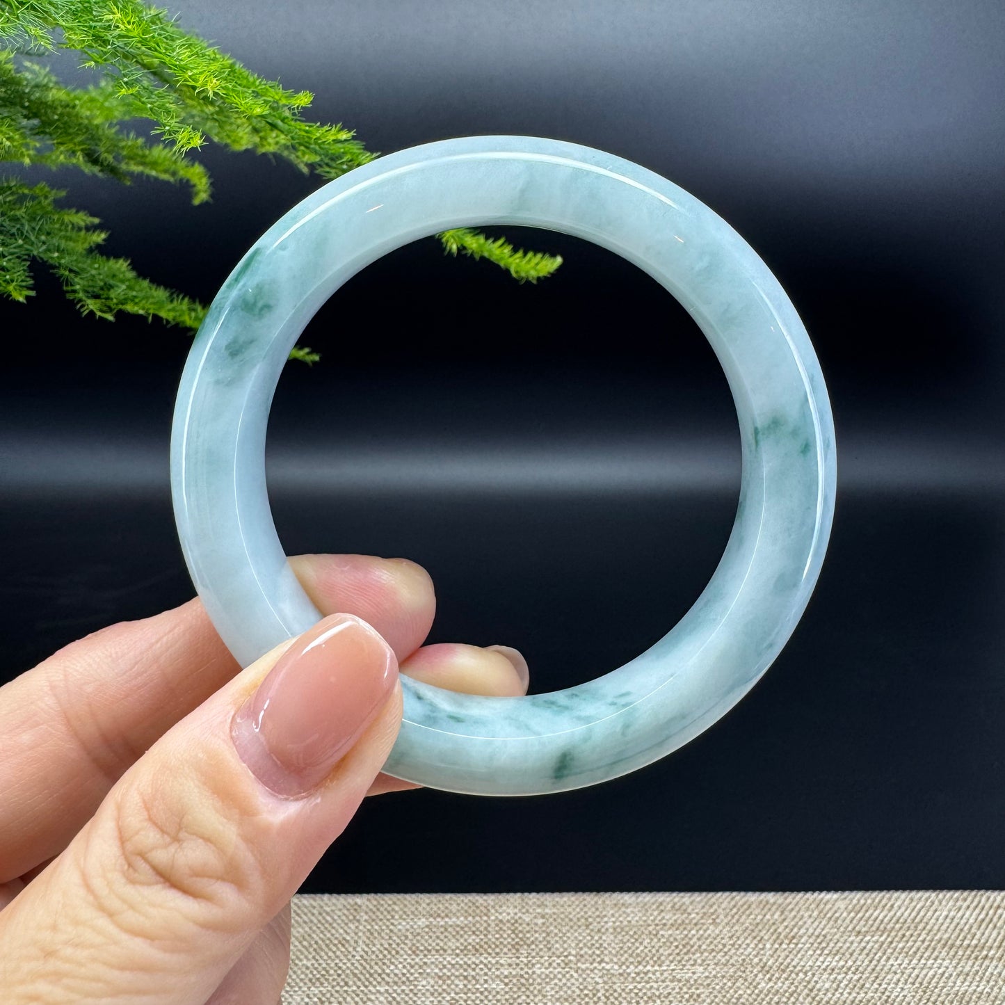 The bangle shape of the half round.The bangle color is blue green.