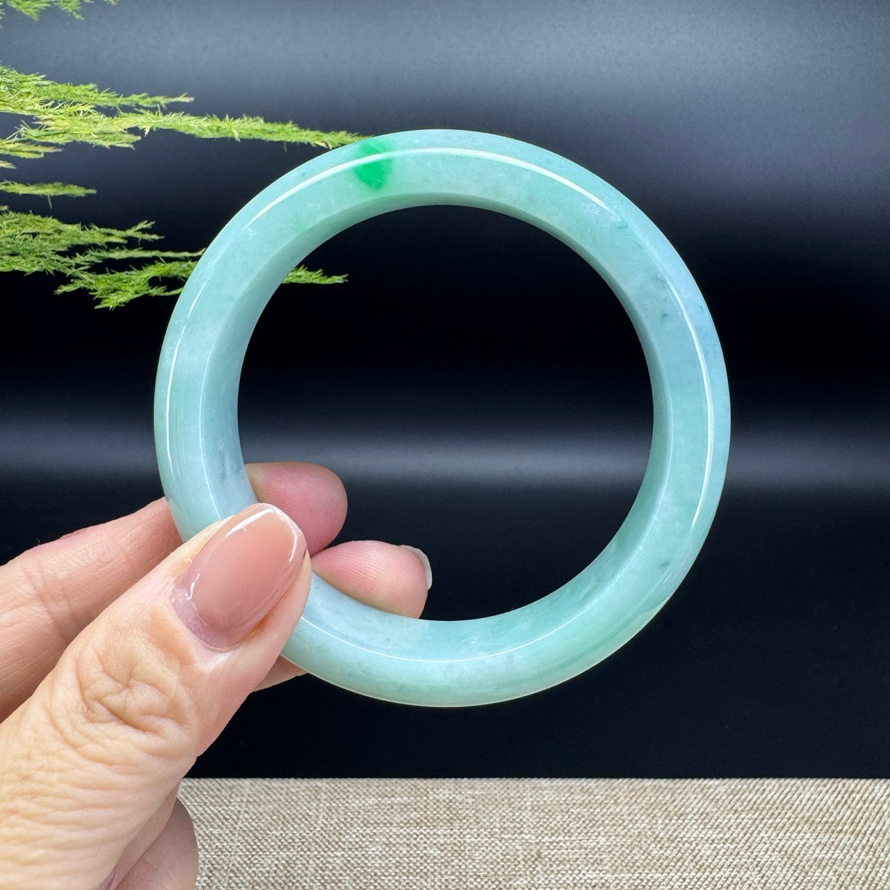 The bangle shape of the half round.The bangle color is icy green and some wuji.