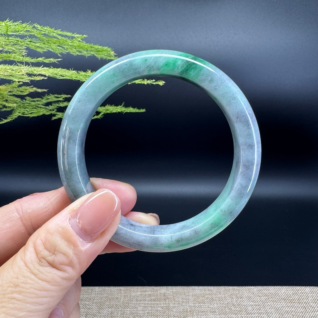 The bangle shape of the half round.The bangle color is black green.