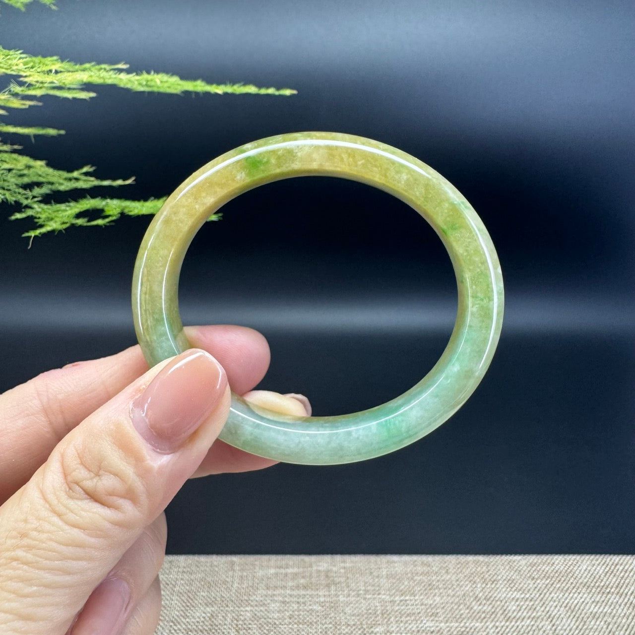 The bangle shape of the oval  half round.The bangle color is yellow green.