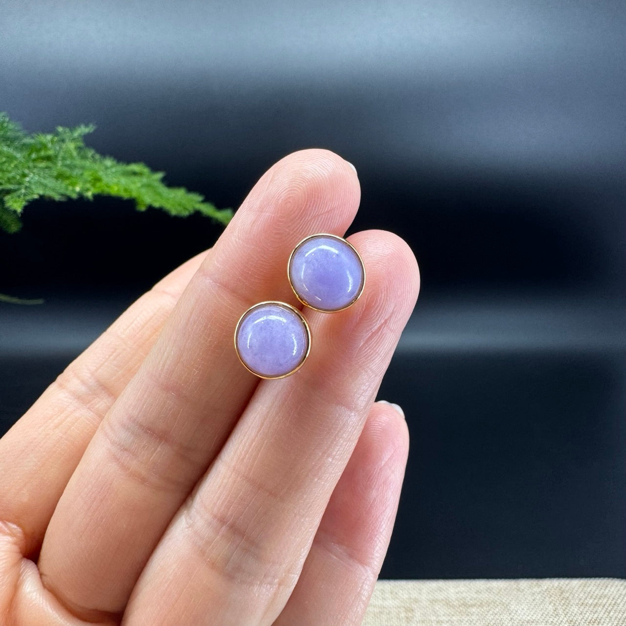 The shape of the earrings  are round.The earrings color are lavender.