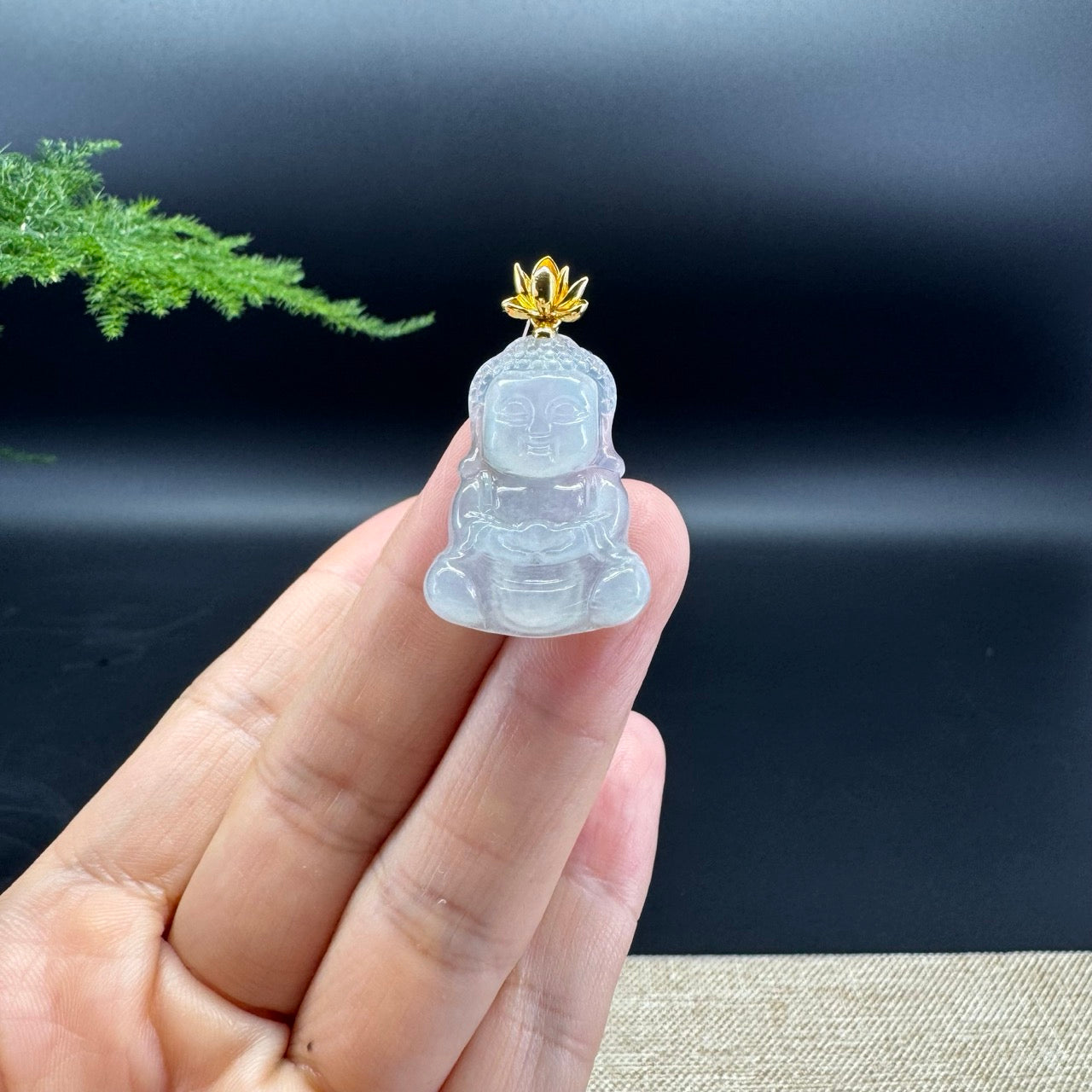 The pendant shape of the buddha.The pendant color is icy.