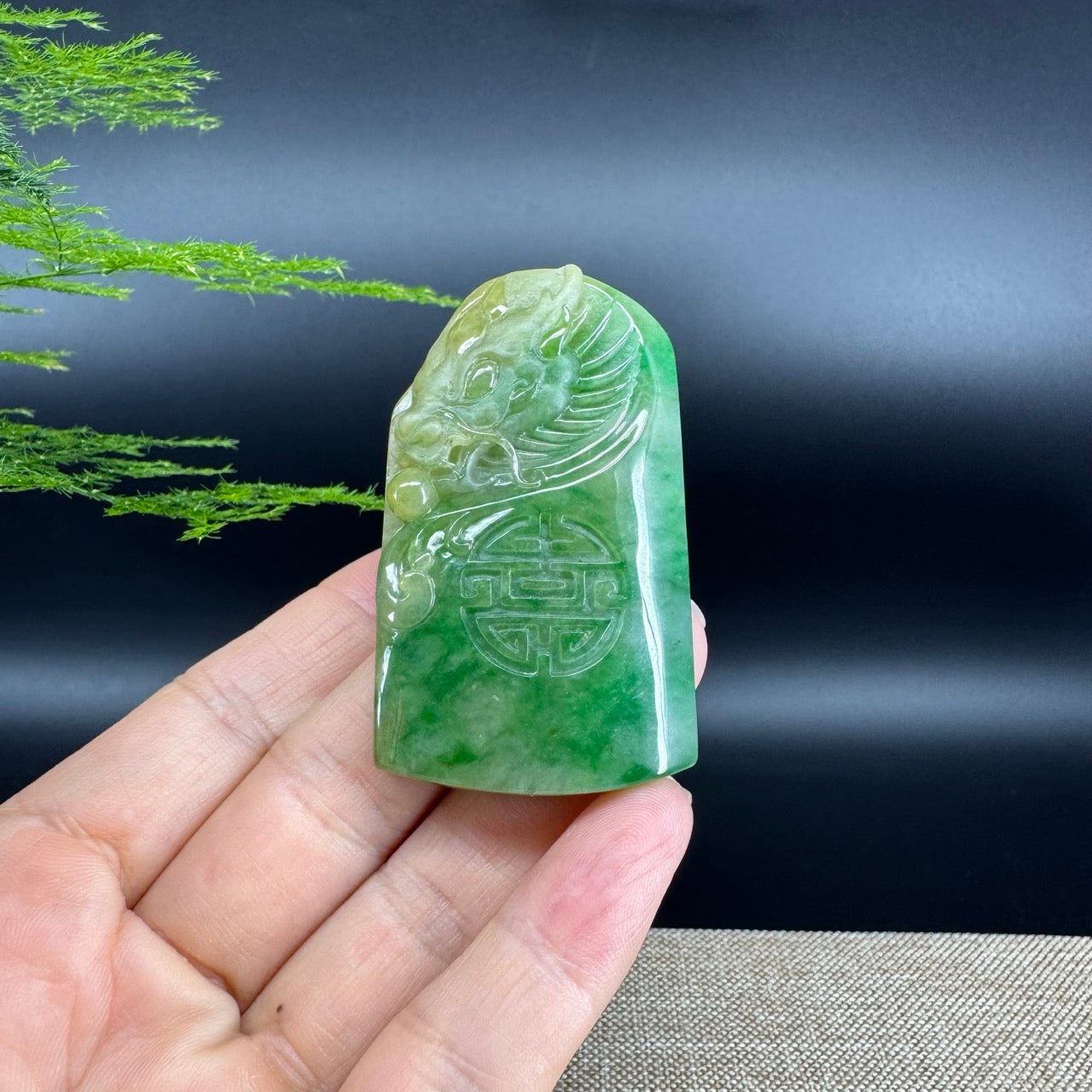The pendant shape of the dragon.The pendant color is yellow green.