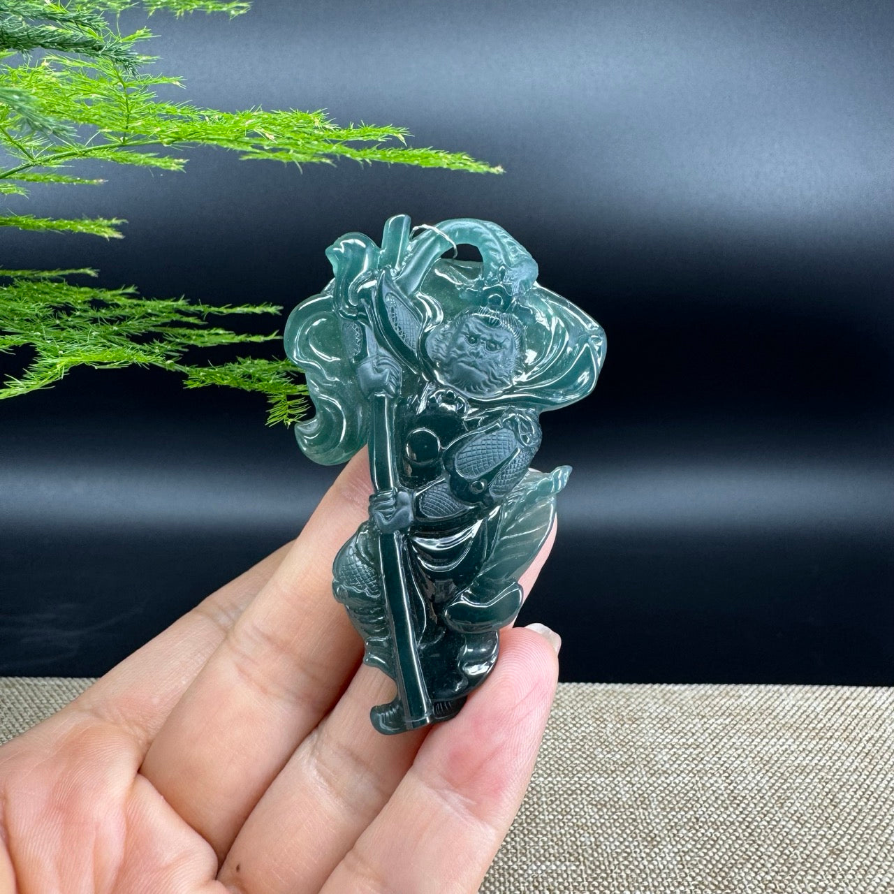 The pendant shape of the monkey king.The pendant color is blue green.