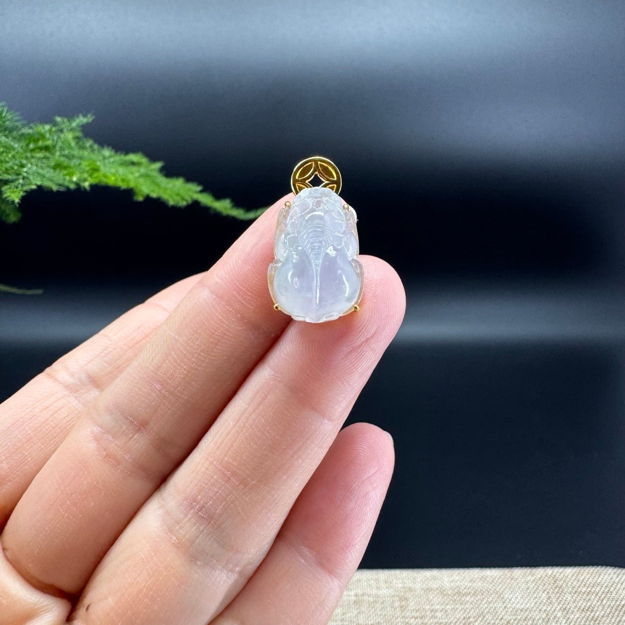 The shape of the pendant is that of a pixiu. The jade is icy color, and it is surrounded by 18k yellow gold.