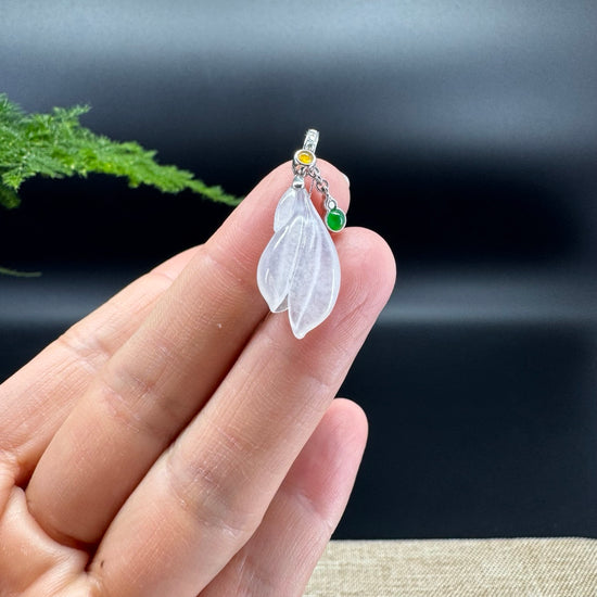 The shape of the pendant is that of a magnolia flower. The jade is icy color, with 18k white gold and diamonds bail.