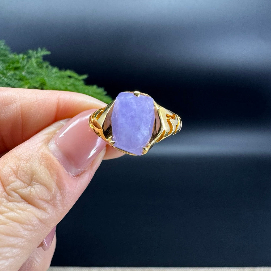 The shape of the ring is irrregular.The ring color is lavender.