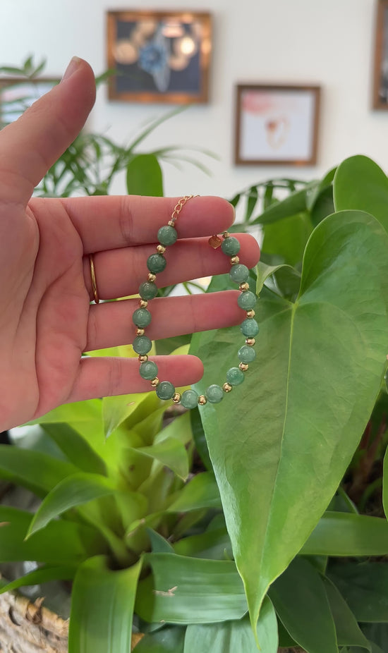 Load and play video in Gallery viewer, RealJade® Co. Genuine Green Jadeite Jade Round Beads Bracelet With 18K Yellow Gold Clasp and Gold Beads ( 7 mm )
